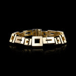 Geometric bracelet set in 18ct yellow gold with baguette cut ruby in clasp by Stefano Canturi