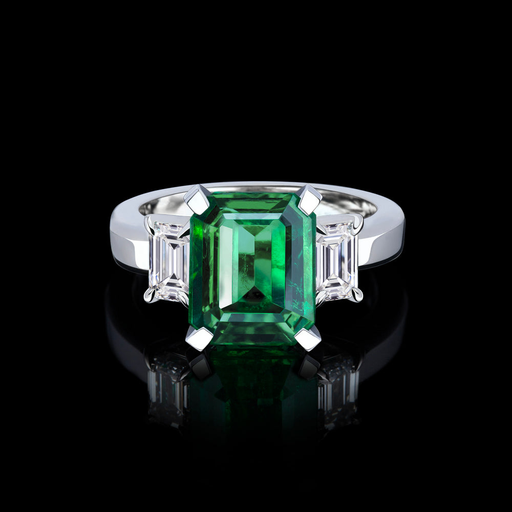 Trilogy emerald cut diamond ring with Zambian green emerald set in 18ct white gold by Stefano Canturi