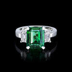 Trilogy emerald cut diamond ring with Zambian green emerald set in 18ct white gold by Stefano Canturi